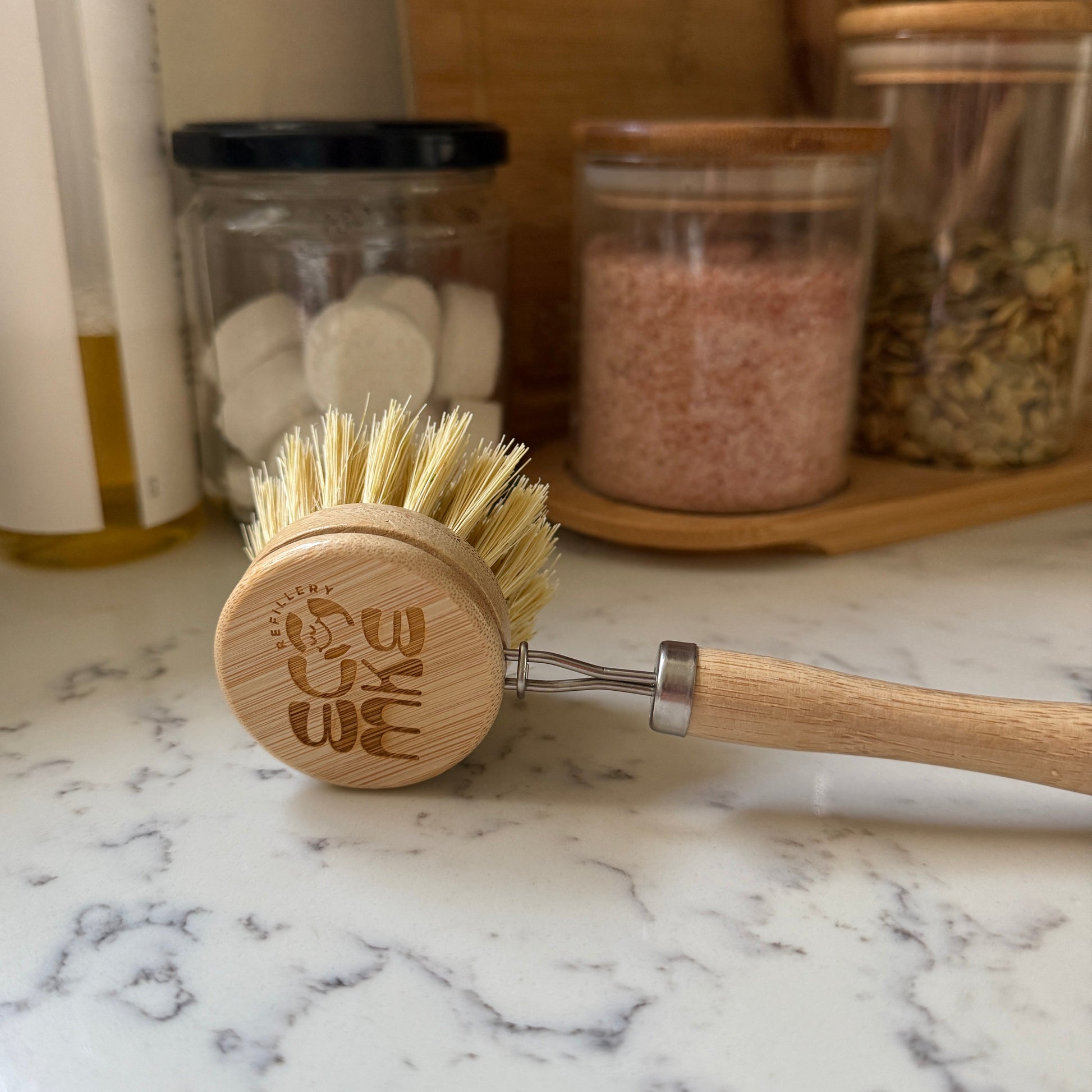 Dish brush with wooden handle and bristles on a kitchen counter